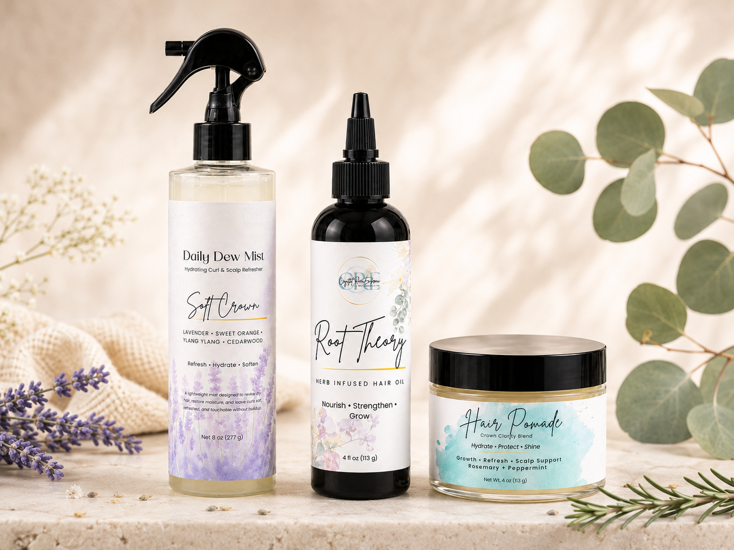 Crystal Rae Embrace hair care trio featuring Daily Dew Mist, Root Theory Herb Infused Hair Oil, and Hair Pomade with botanical accents.