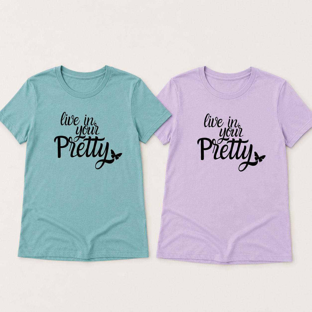 Soft teal and soft lilac Live in Your Pretty graphic tees displayed side by side.
